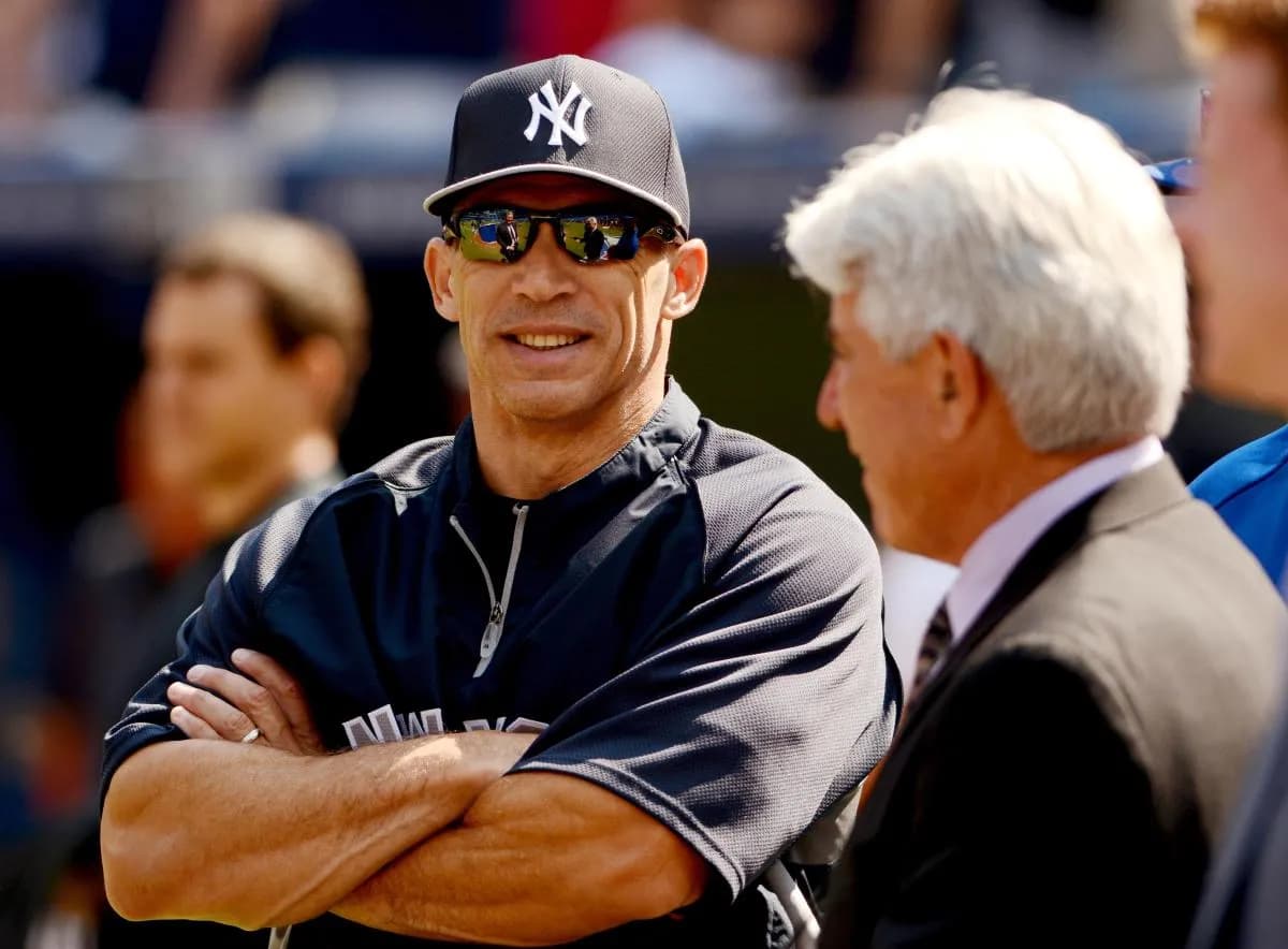 New York Yankees manager Joe Girardi smiles as he chats with former catcher turned Toronto Blue Jays broadcaster Buck Martinez (right) during batting practice at Rogers Centre.