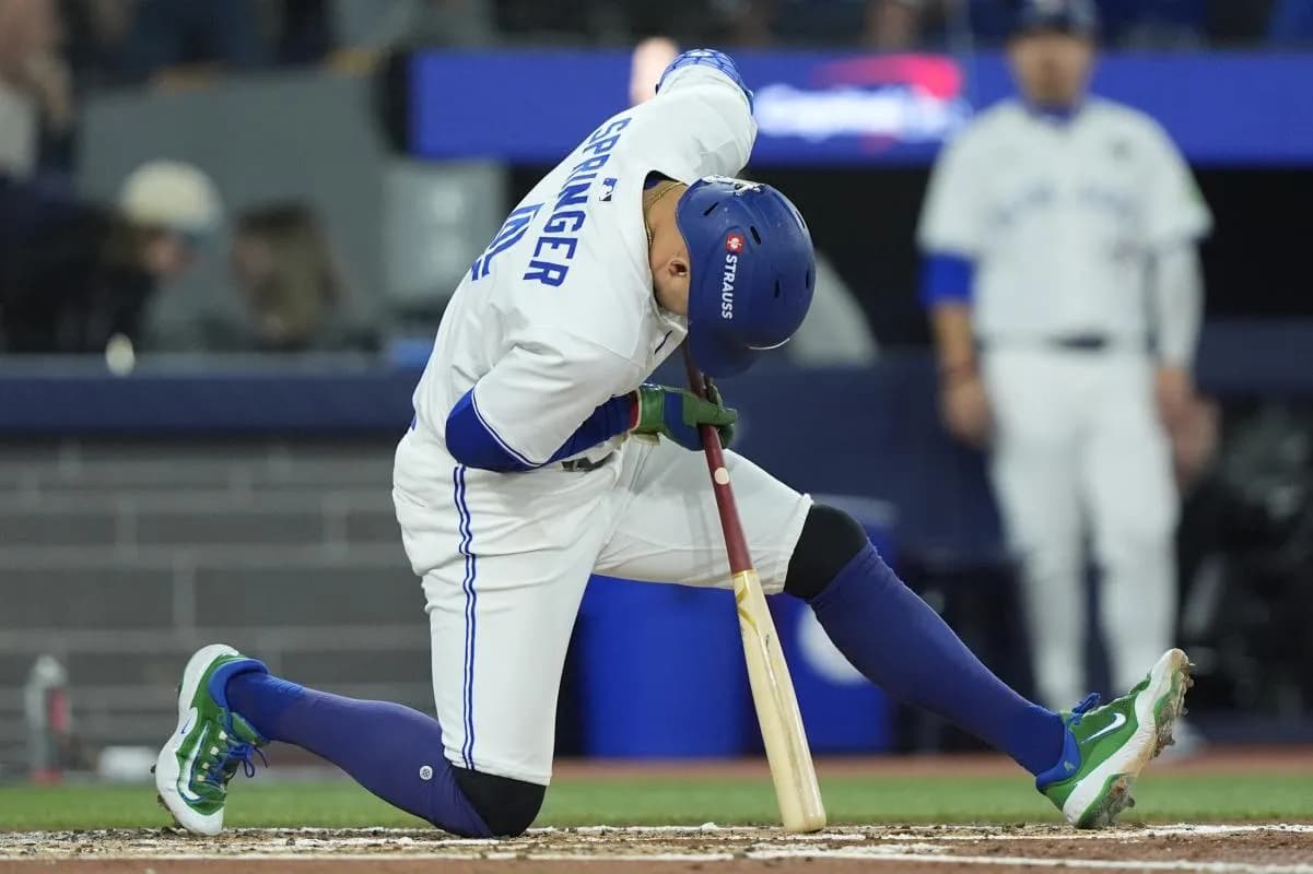 Toronto Blue Jays right fielder George Springer (4) reacts after a swing against the Los Angeles Dodgers in the third inning during game seven of the 2025 MLB World Series at Rogers Centre