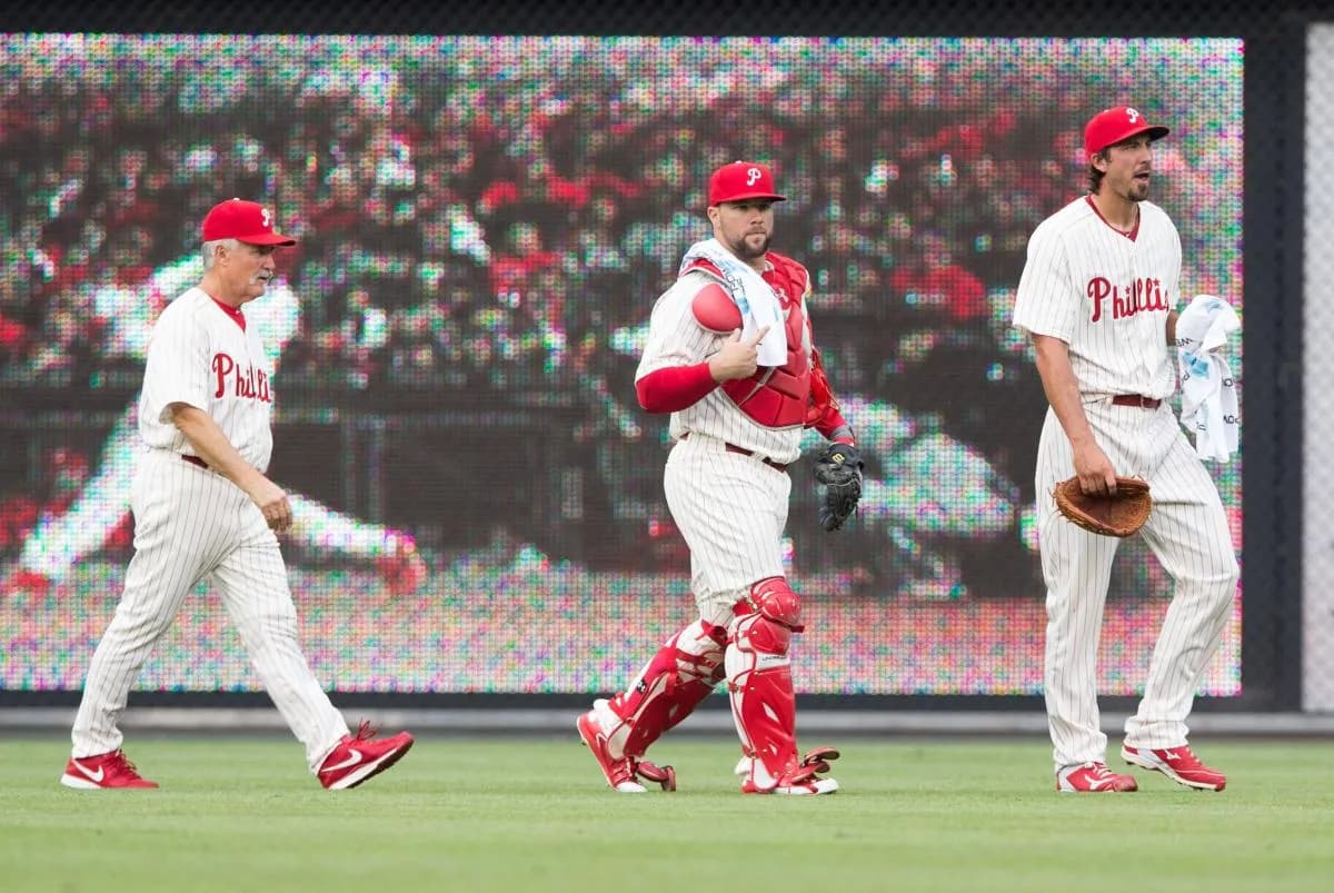 Philadelphia Phillies relief pitcher Phillippe Aumont (R) and catcher Cameron Rupp (29) and pitching coach Bob McClure (22) walk from the outfield to begin a game against the St. Louis Cardinals at Citizens Bank Park. The St. Louis Cardinals won 12-4.
