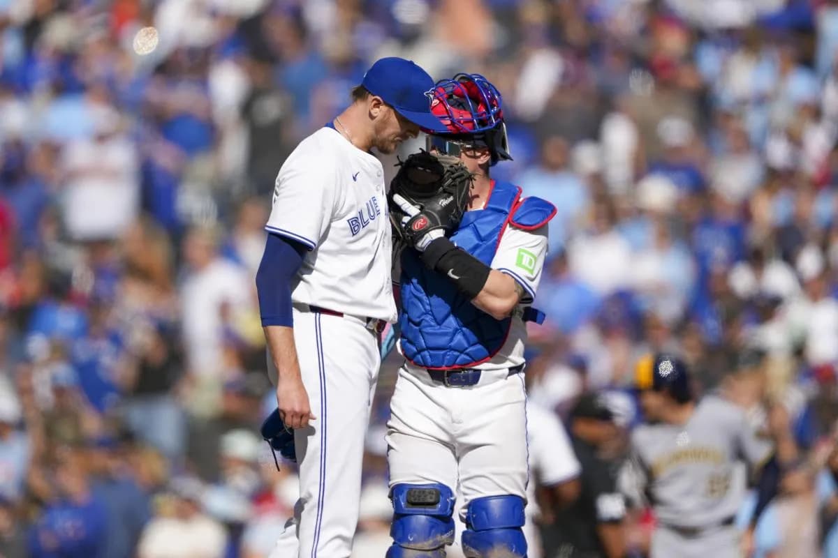 Toronto Blue Jays pitcher Jeff Hoffman (23) huddles with catcher Tyler Heineman (55) during the ninth inning in their MLB game against the Milwaukee Brewers at Rogers Centre.