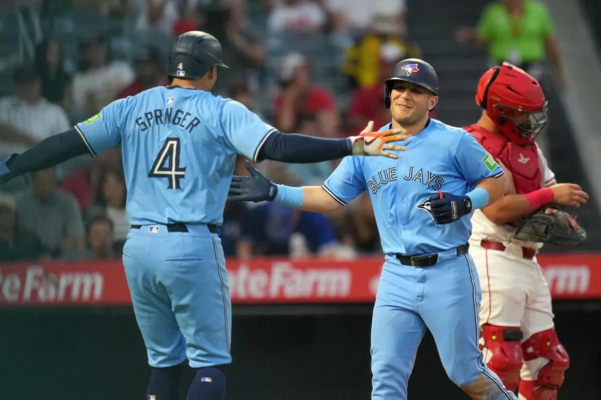 Toronto Blue Jays left fielder Daulton Varsho (25) celebrates with right fielder George Springer (4) after hitting a three-run home run in the fifth inning against the Los Angeles Angels at Angel Stadium