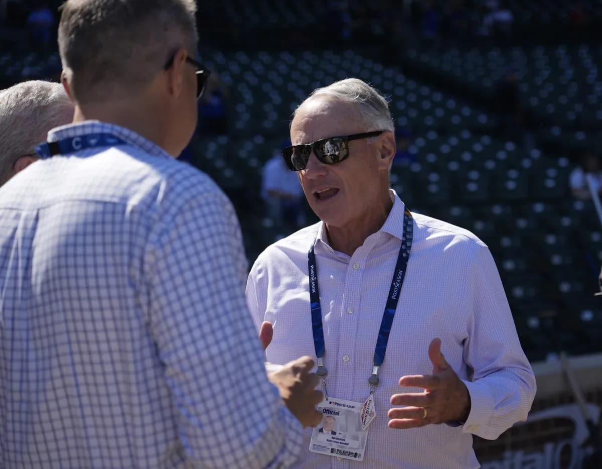 MLB commissioner Rob Manfred speaks with Chicago Cubs owner Tom Ricketts before game one of the Wildcard between the Chicago Cubs and the San Diego Padres round for the 2025 MLB playoffs at Wrigley Field.