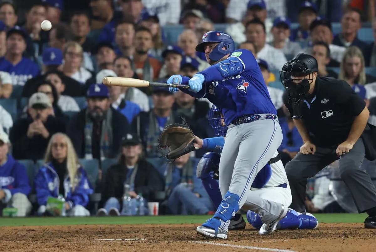 Toronto Blue Jays first baseman Ty France singles during the tenth inning against the Los Angeles Dodgers in game three of the 2025 MLB World Series at Dodger Stadium.