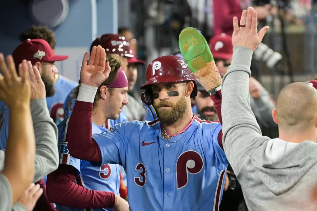 Philadelphia Phillies first baseman Bryce Harper (3) celebrates in the dugout after scoring on a Los Angeles Dodgers throwing error during the fourth inning during game three of the NLDS round for the 2025 MLB playoffs at Dodger Stadium.