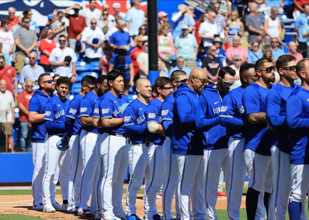Toronto Blue Jays manager John Schneider (14) and teammates look on during the National Anthem against the Philadelphia Phillies at TD Ballpark.