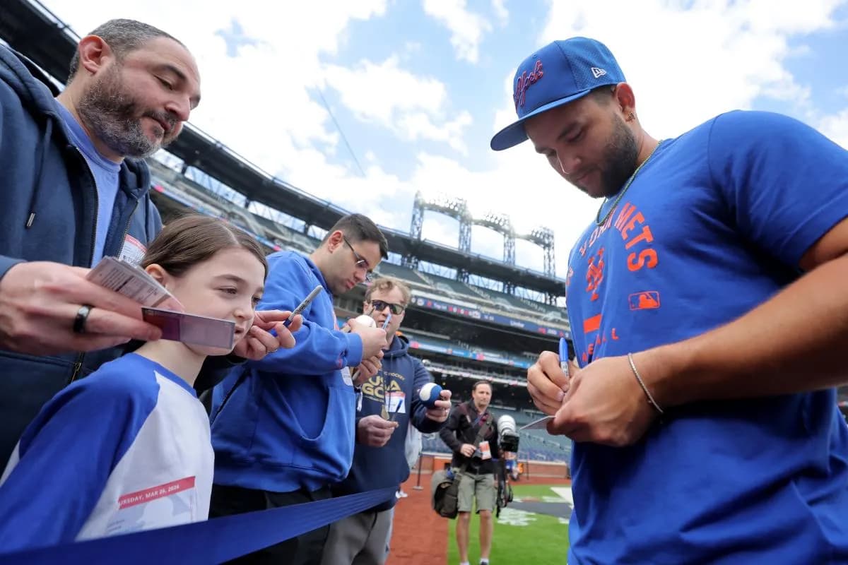 New York Mets third baseman Bo Bichette (19) signs autographs before an opening day game against the Pittsburgh Pirates at Citi Field.