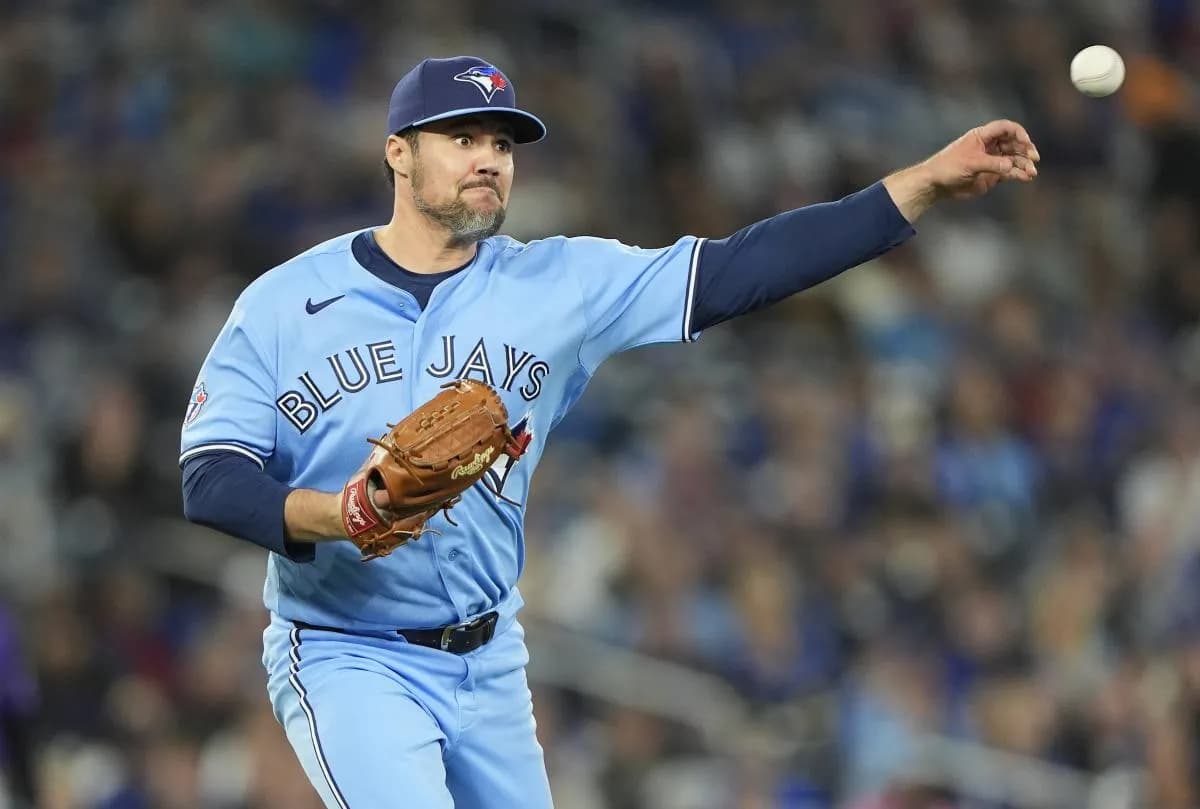 Toronto Blue Jays pitcher Brendon Little (54) throws to first base to get out Colorado Rockies right fielder Troy Johnston (20) during the tenth inning at Rogers Centre.