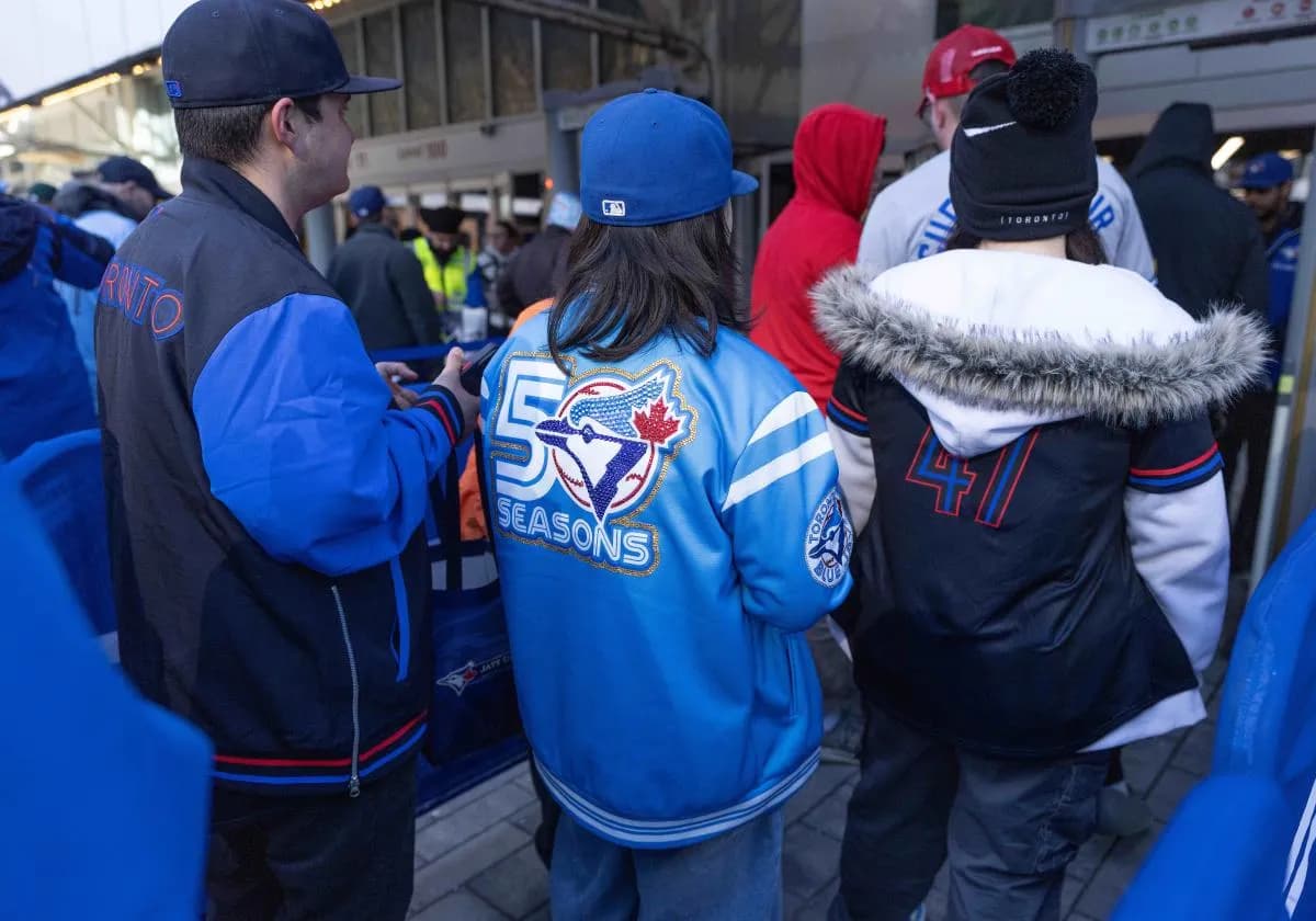 Fans wait in line before the Opening Day game between the Athletics and Toronto Blue Jays at Rogers Centre.