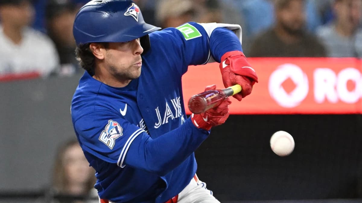 Toronto Blue Jays second baseman Ernie Clement (22) bunts to get on base against the Los Angeles Dodgers in the seventh inning at Rogers Centre.