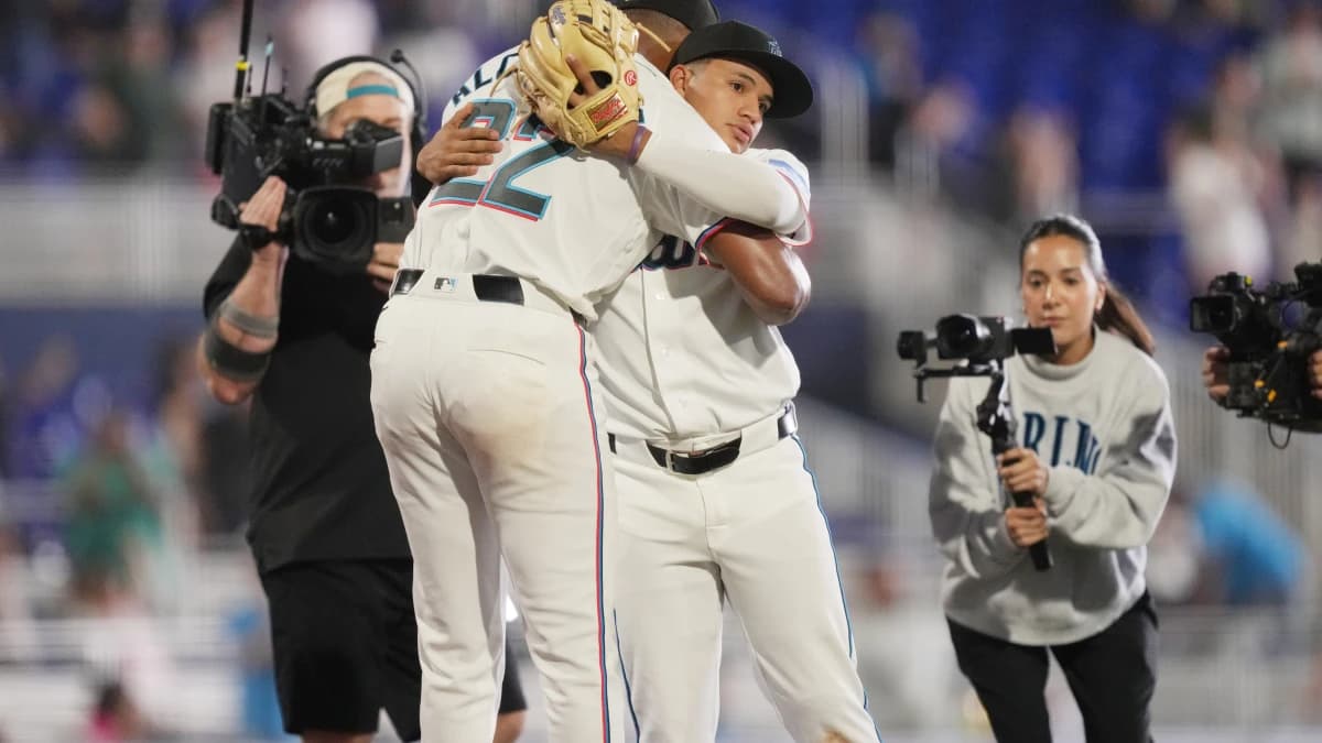 Miami Marlins starting pitcher Sandy Alcantara (22) gets a hug following his complete game shutout win over the Chicago White Sox by third baseman Javier Sanoja (8) at loanDepot Park.