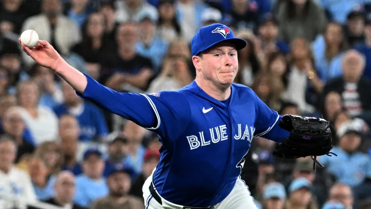 Toronto Blue Jays relief pitcher Louis Varland (77) throws to first base to force out Los Angeles Dodgers first baseman Freddie Freeman (not shown) in the eighth inning at Rogers Centre.