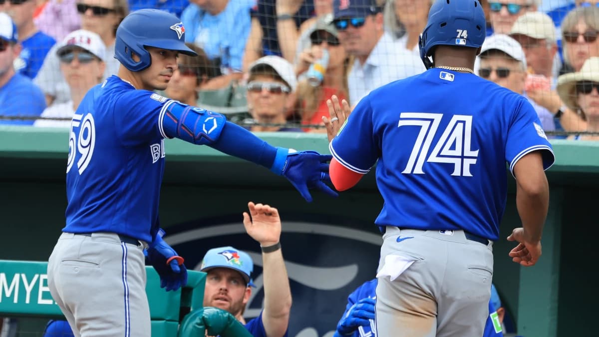 Toronto Blue Jays designated hitter Eloy Jimenez (74) scores a run by Toronto Blue Jays catcher Brandon Valenzuela (59) sacrifice hit at JetBlue Park at Fenway South.