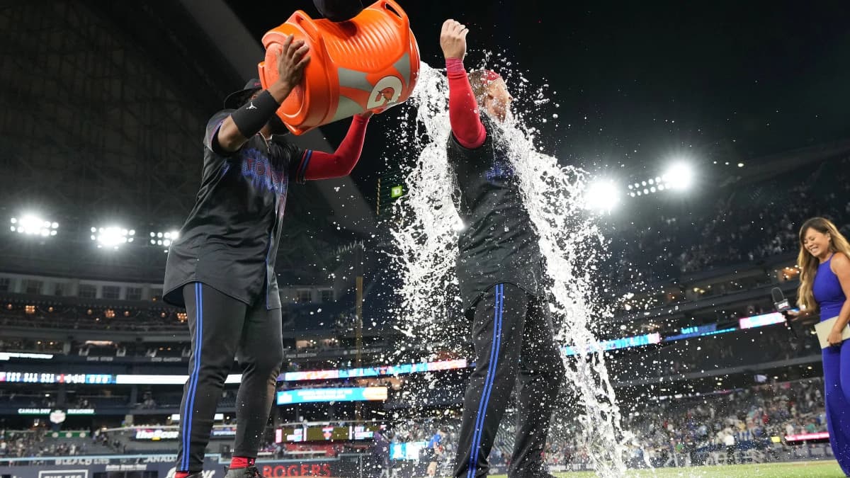 Toronto Blue Jays first basema Vladimir Guerrero Jr. (27) pours water on designated hitter Justin Turner (2) after a game against the Tampa Bay Rays at Rogers Centre.