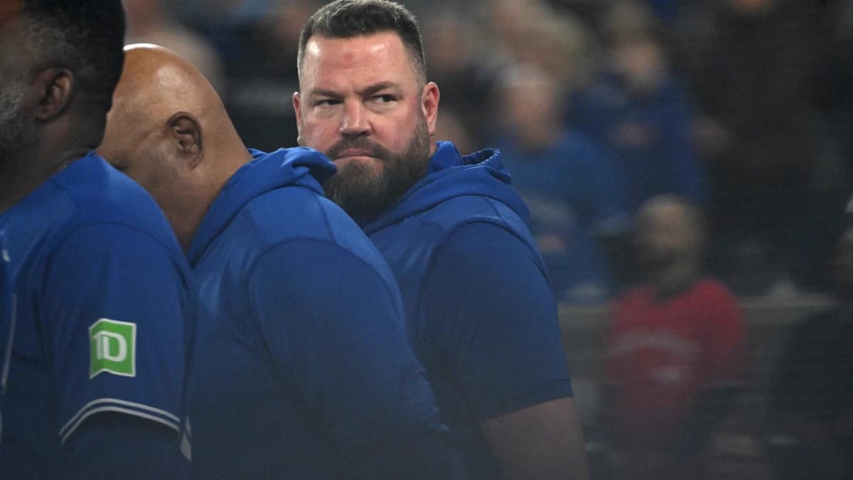 Toronto Blue Jays manager John Schneider (14) looks back towards the dugout as he lines up for the pre-game national anthems before playing the Los Angeles Dodgers at Rogers Centre.