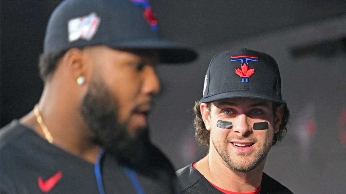 Toronto Blue Jays second baseman Ernie Clement (22, right) speaks with first baseman Vladimir Guerrero Jr. (27) before taking the field against the Minnesota Twins at Rogers Centre.
