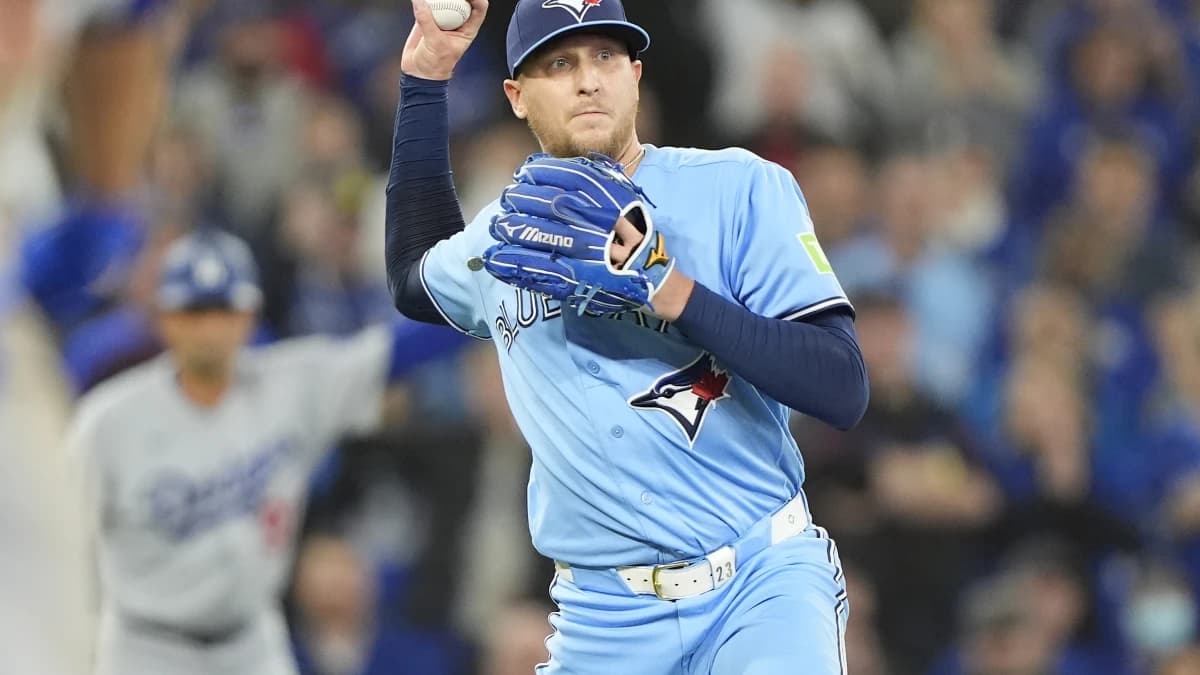 Toronto Blue Jays pitcher Jeff Hoffman (23) throws to first base to get out Los Angeles Dodgers third baseman Max Muncy (not pictured)during the ninth inning at Rogers Centre.