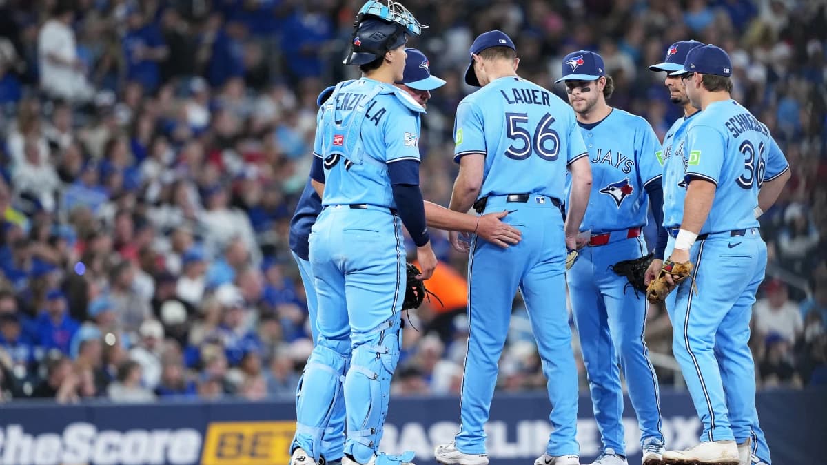 Toronto Blue Jays starting pitcher Eric Lauer (56) is relieved by manager John Schneider (14) against the Minnesota Twins during he sixth inning at Rogers Centre.
