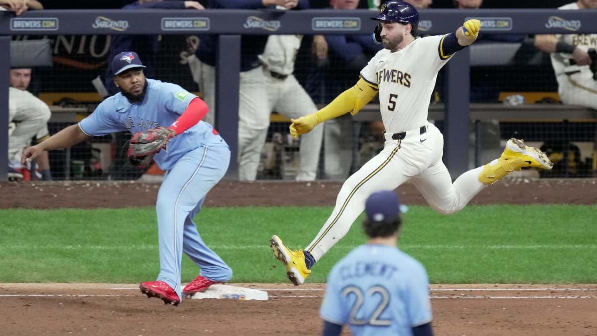 Milwaukee Brewers center fielder Garrett Mitchell (5) beats the throws to Toronto Blue Jays first baseman Vladimir Guerrero Jr. (27) during the eighth inning of their game Tuesday, April 14, 2026 at American Family Field in Milwaukee, Wisconsin.