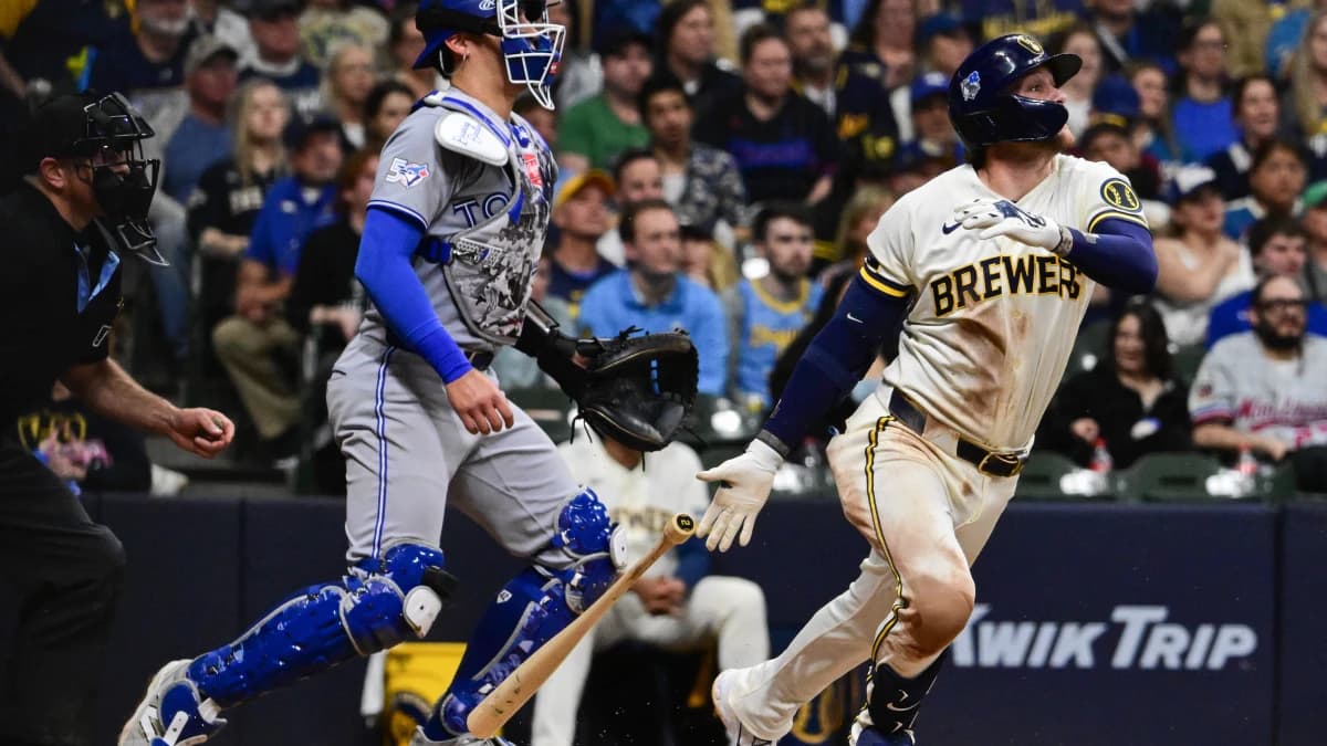 Milwaukee Brewers second baseman Brice Turang (2) drives in the go-ahead run with a groundout in the eighth inning as Toronto Blue Jays catcher Brandon Valenzuela (59) looks on at American Family Field.