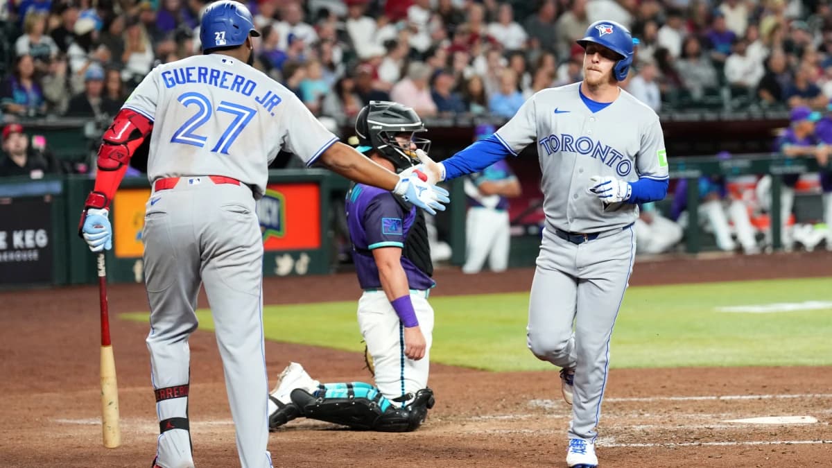 Toronto Blue Jays center fielder Myles Straw (3) slaps hands with Toronto Blue Jays first baseman Vladimir Guerrero Jr. (27) after hitting a solo home run against the Arizona Diamondbacks during the sixth inning at Chase Field