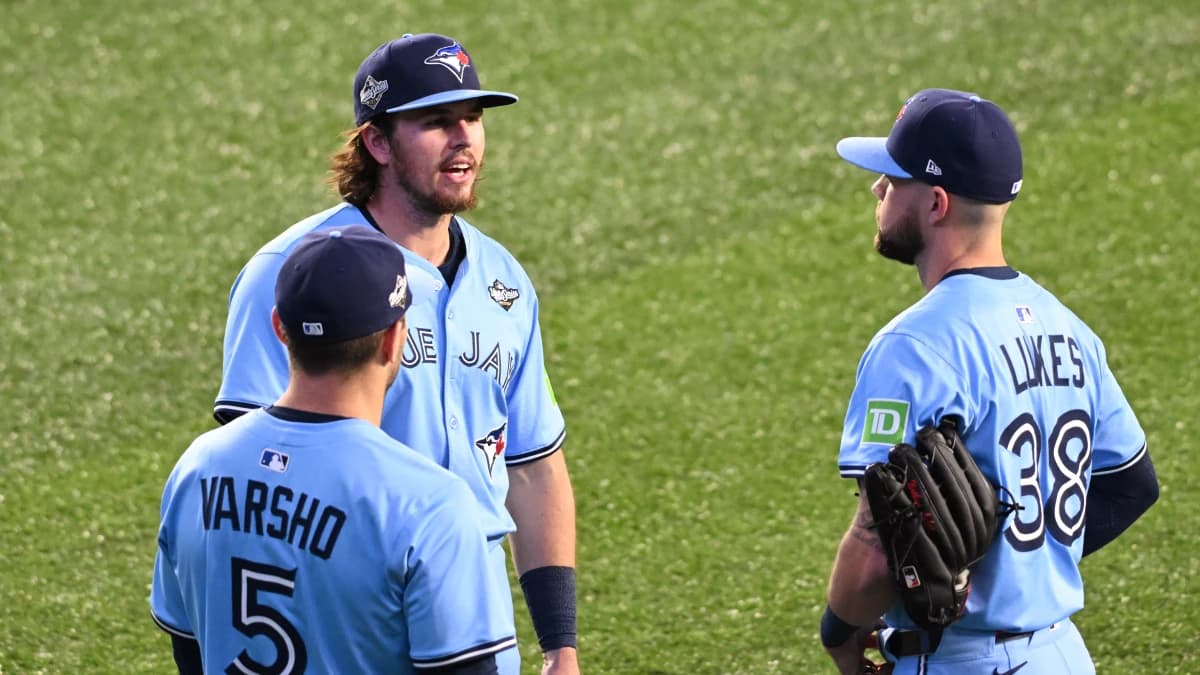 Toronto Blue Jays center fielder Daulton Varsho (5) and third baseman Addison Barger (47) and right fielder Nathan Lukes (38) talk in the outfield in the eighth inning against the Los Angeles Dodgers during game six of the 2025 MLB World Series at Rogers Centre.