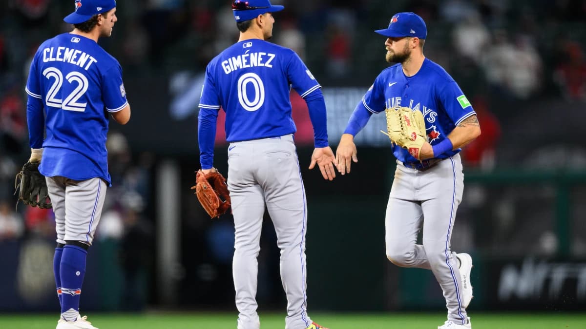 Toronto Blue Jays right fielder Nathan Lukes (38), right, greets second baseman Andres Gimenez (0) after defeating the Los Angeles Angels at Angel Stadium.