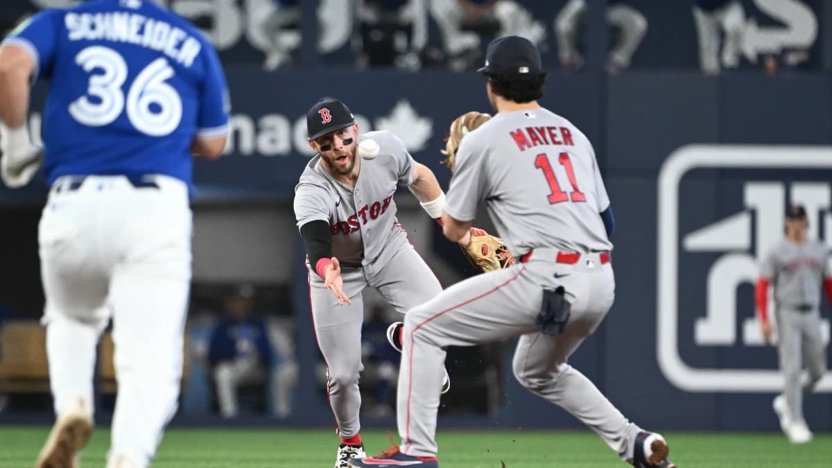 Boston Red Sox shortstop Trevor Story (10) throws the ball to second baseman Marcelo Mayer (11) to start a double play against the Toronto Blue Jays in the third inning at Rogers Centre.