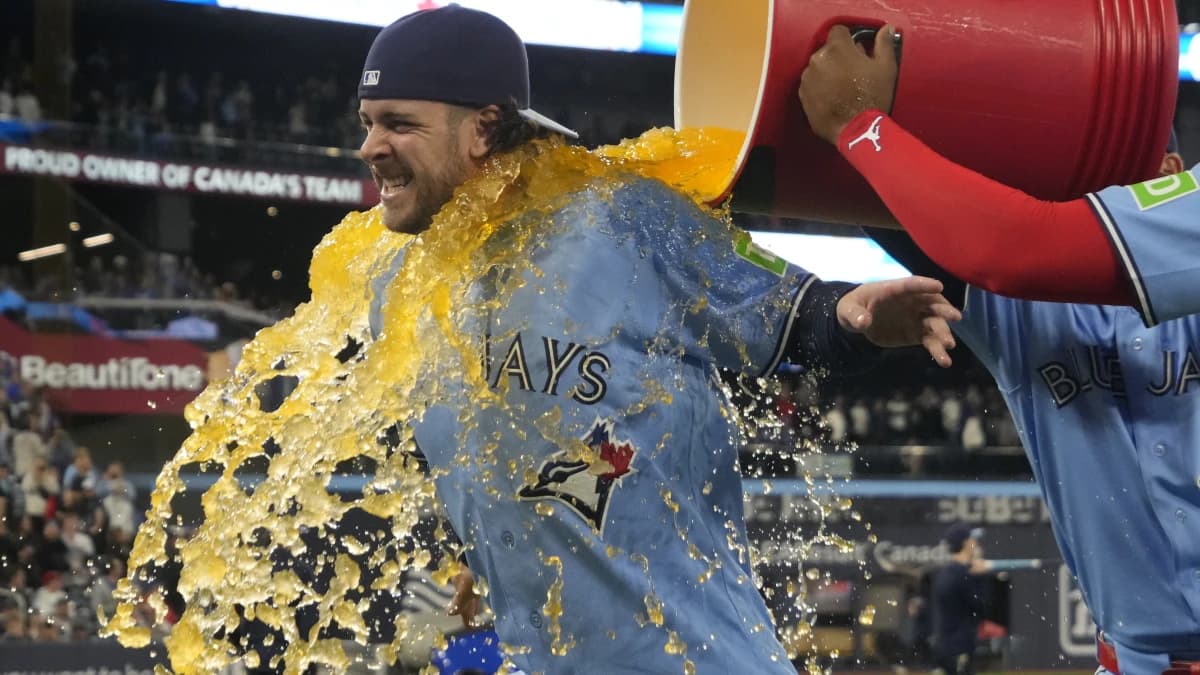Toronto Blue Jays second baseman Ernie Clement (22) gets soaked with gatorade by first baseman Vladimir Guerrero Jr. (not pictured) after a win over the Boston Red Sox at Rogers Centre.