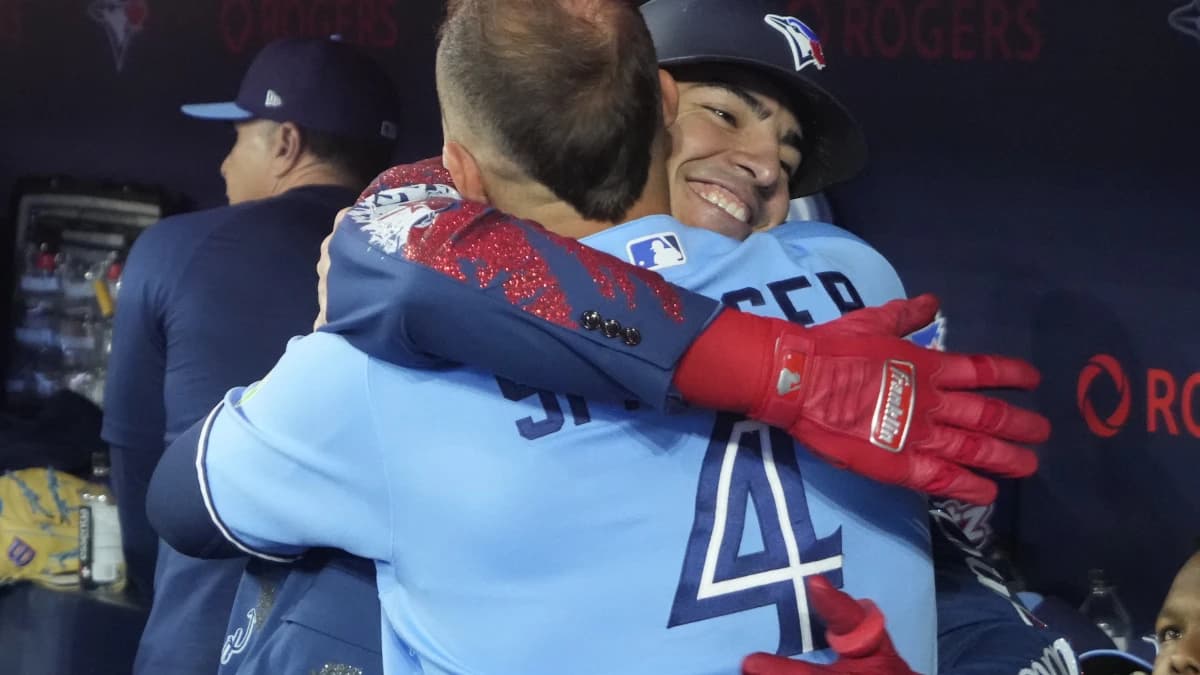 Toronto Blue Jays designated hitter George Springer (4) congratulates catcher Brandon Valenzuela (59) on hitting a solo home run against the Boston Red Sox in the eighth inning at Rogers Centre.