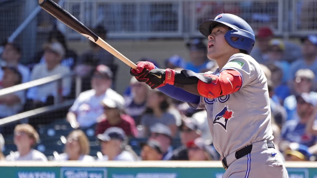 Toronto Blue Jays third baseman Kazuma Okamoto (7) hits a two run home run against the Minnesota Twins in the ninth inning at Target Field.