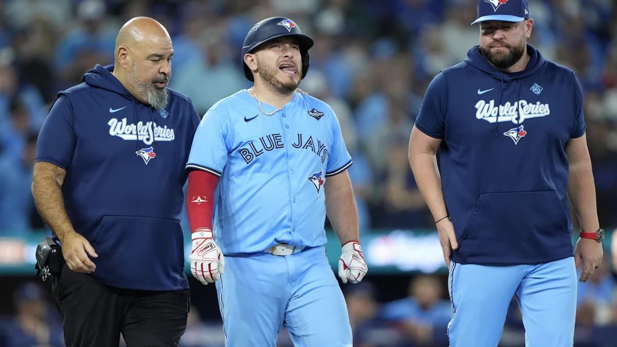 Toronto Blue Jays catcher Alejandro Kirk (30) walks to first after being hit by a pitch against the Los Angeles Dodgers in the ninth during game six of the 2025 MLB World Series at Rogers Centre.