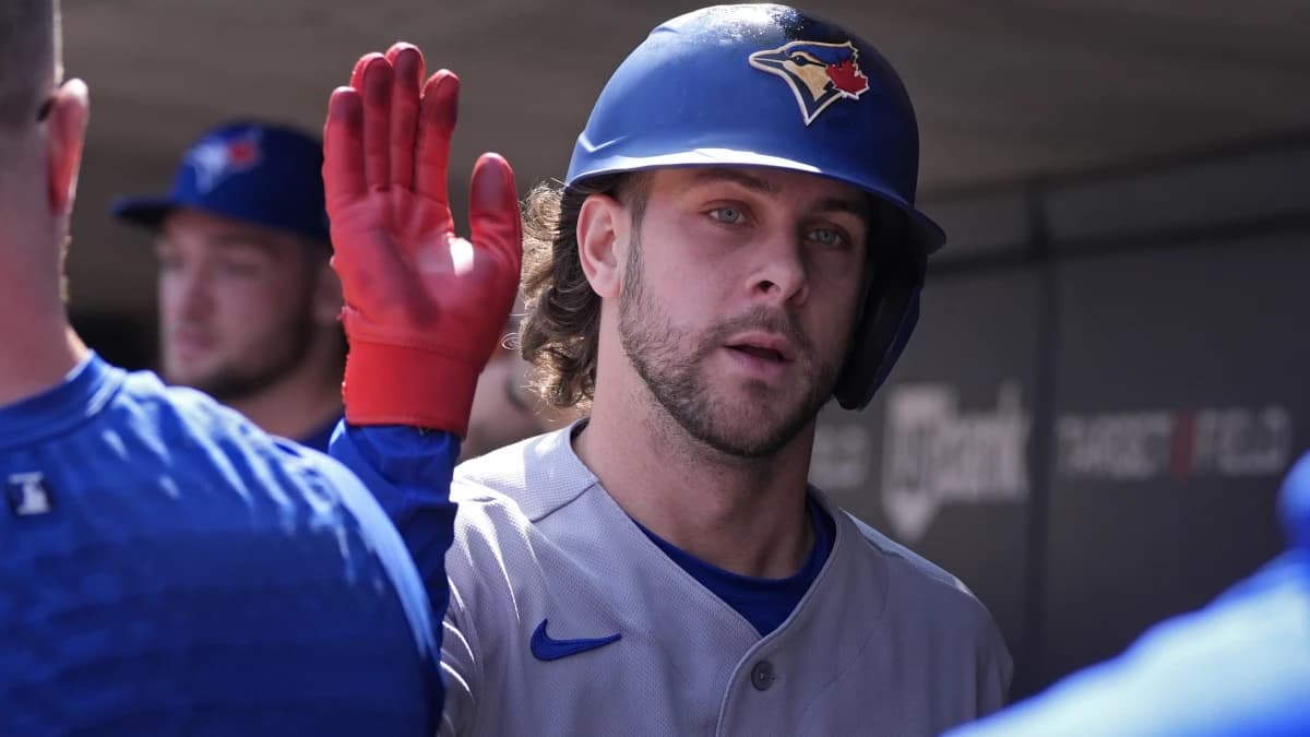 Toronto Blue Jays shortstop Ernie Clement (22) celebrates his run against the Minnesota Twins in the eighth inning on a single by third baseman Kazuma Okamoto (not pictured) at Target Field.