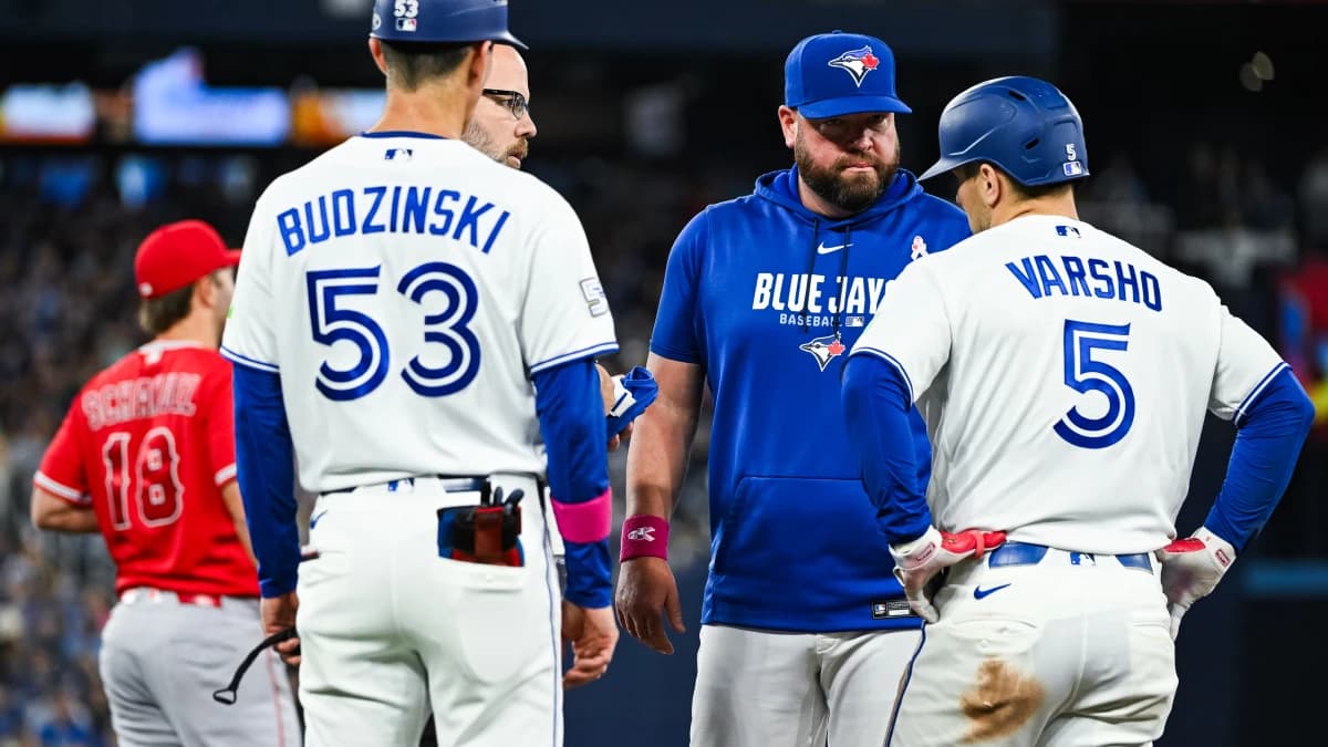 Toronto Blue Jays manager John Schneider checks in with center fielder Daulton Varsho (5) after a potential injury against the Los Angeles Angels in the eigth inning at Rogers Centre.
