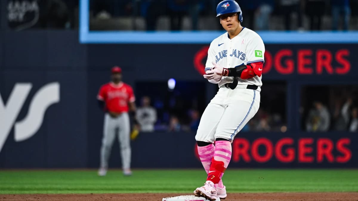 Toronto Blue Jays third baseman Kazuma Okamoto (7) gets to second base after hitting a RBI double against the Los Angeles Angels in the first inning at Rogers Centre.