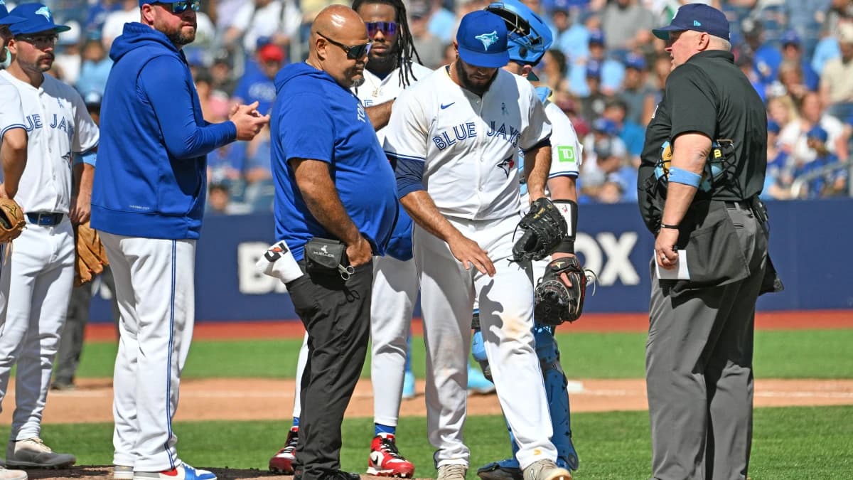 Toronto Blue Jays relief pitcher Yimi Garcia (93) is relieved by Toronto Blue Jays manager John Schneider (14) in the ninth inning against the Cleveland Guardians at Rogers Centre.