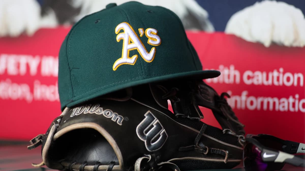 A detailed view of an Oakland Athletics hat and glove on the field against the Atlanta Braves in the sixth inning at Truist Park