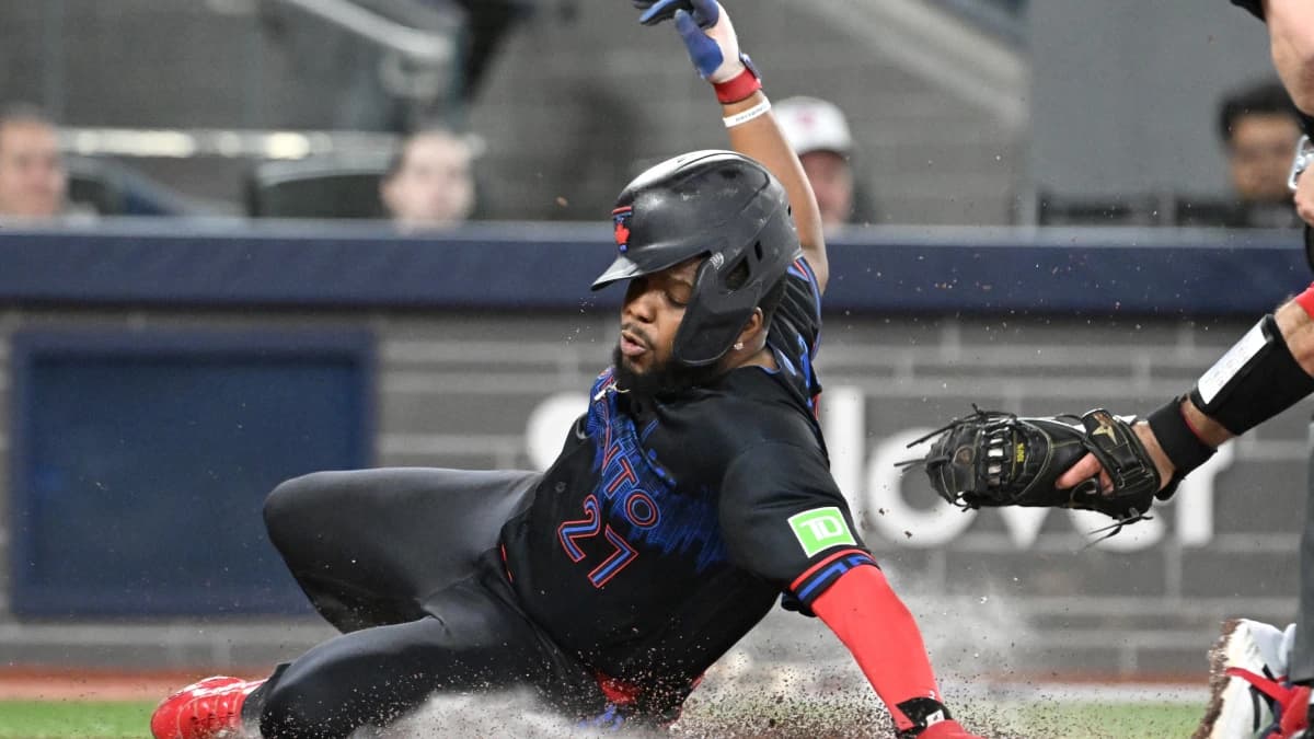 Toronto Blue Jays first baseman Vladimir Guerrero Jr. (27) scores against Los Angeles Angels catcher Sebastian Rivero (38) in the third inning at Rogers Centre.