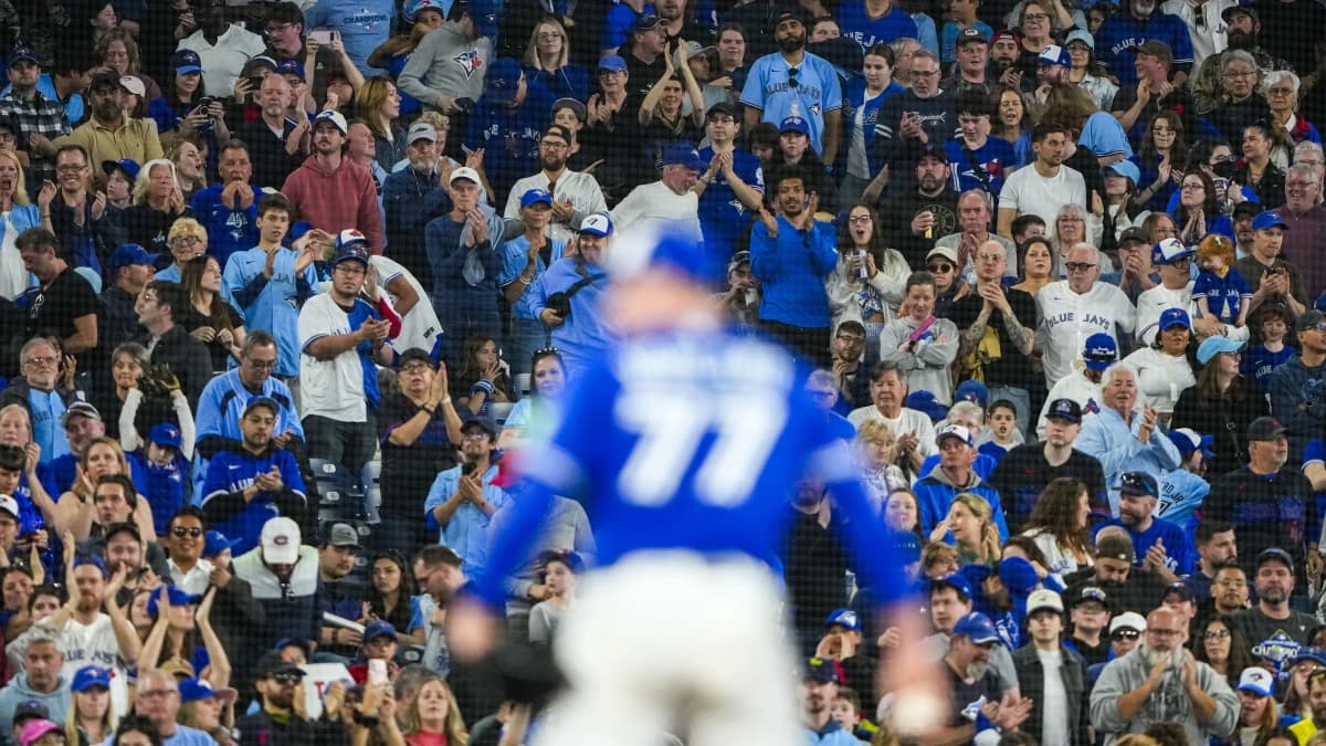 Toronto Blue Jays fans cheer on Toronto Blue Jays pitcher Louis Varland (77) during the ninth inning against the Cleveland Guardians at Rogers Centre.