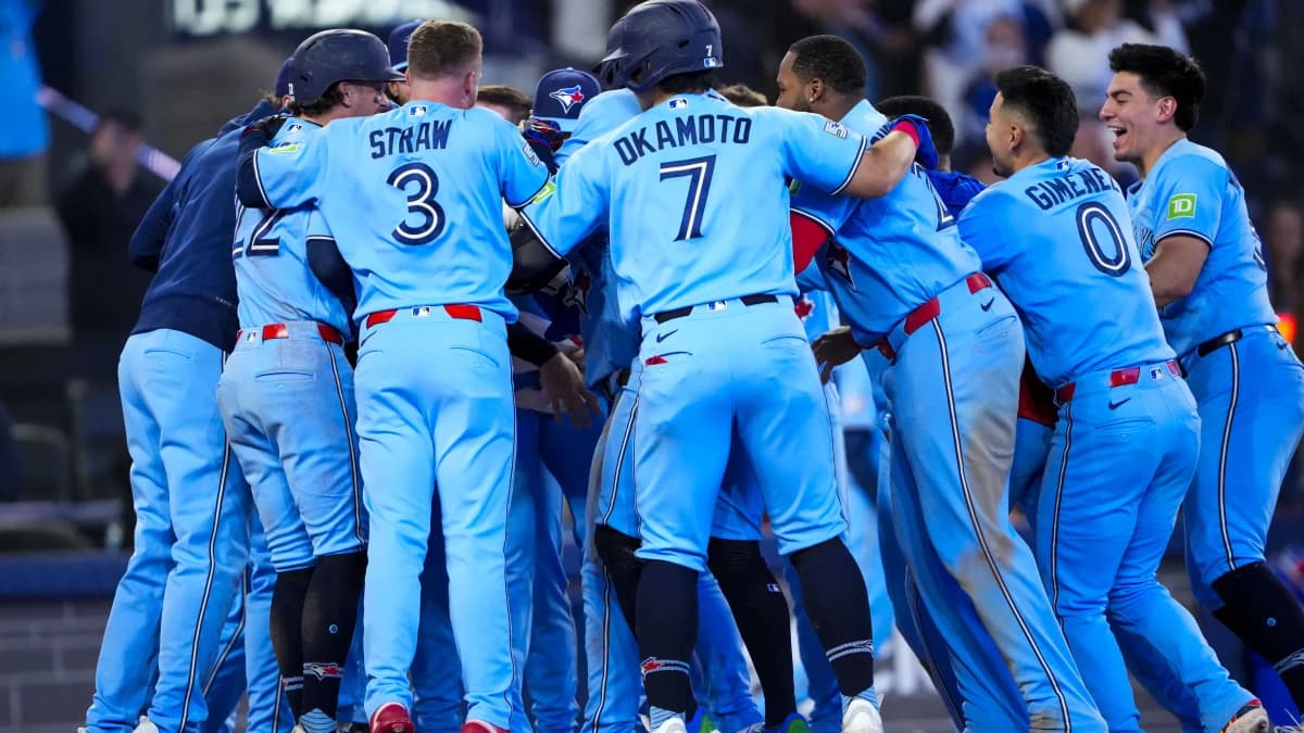 Toronto Blue Jays center fielder Daulton Varsho (5) celebrates hitting a grand slam walk off to defeat the Tampa Bay Rays during the tenth inning with teammates at Rogers Centre.