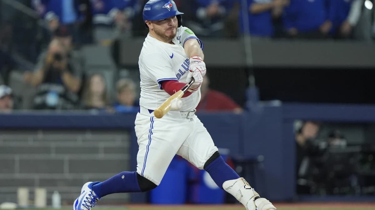 Toronto Blue Jays catcher Alejandro Kirk (30) hits a single against the Los Angeles Dodgers in the seventh inning during game seven of the 2025 MLB World Series at Rogers Centre.