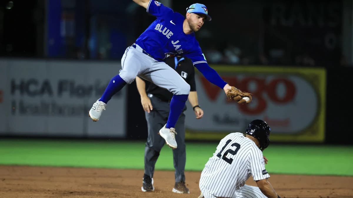 Toronto Blue Jays infielder Rafael Lantigua (72) attempted to tag out New York Yankees center fielder Trent Grisham (12) as he stole second base during the fifth inning at George M. Steinbrenner Field.