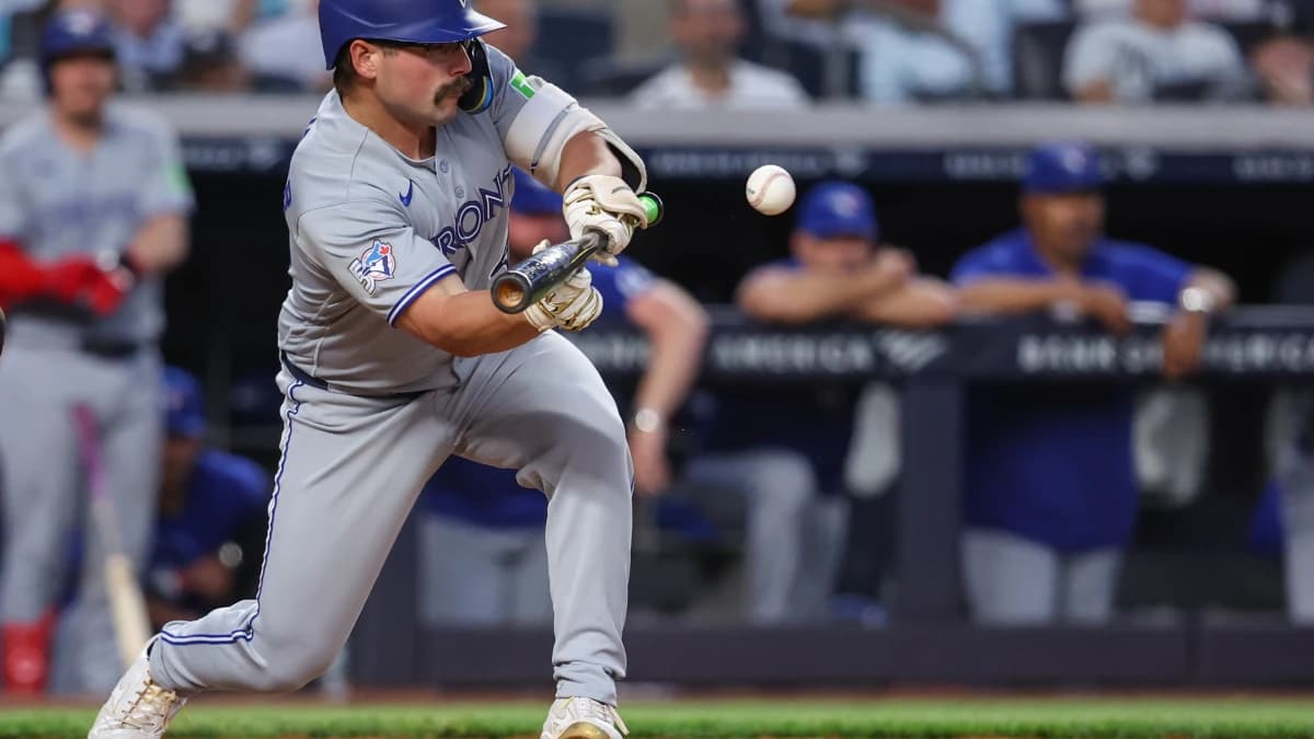 Toronto Blue Jays second baseman Davis Schneider (36) drops down a sacrifice bunt in the fourth inning against the New York Yankees at Yankee Stadium.