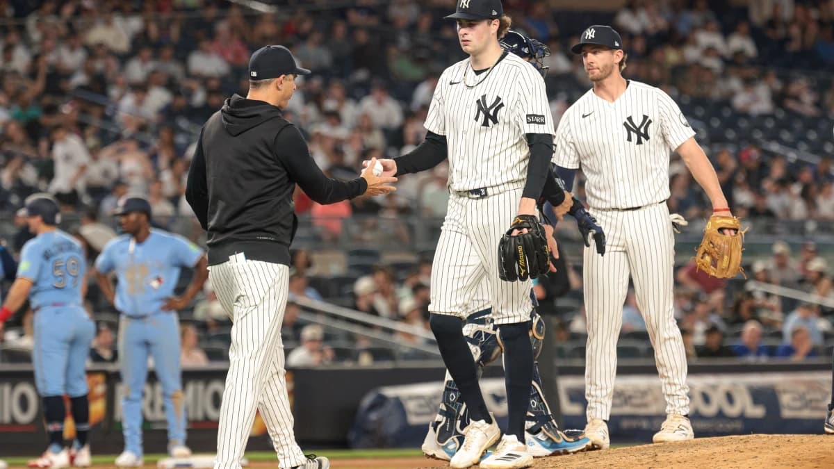 New York Yankees manager Aaron Boone (17) take the ball from pitcher Cam Schlittler (31) during the seventh inning against the Toronto Blue Jays at Yankee Stadium.
