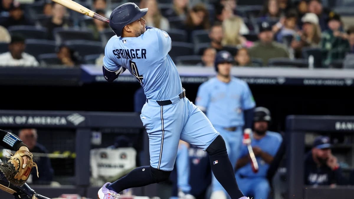 Toronto Blue Jays designated hitter George Springer (4) hits a solo home run in the seventh inning against the New York Yankees at Yankee Stadium.