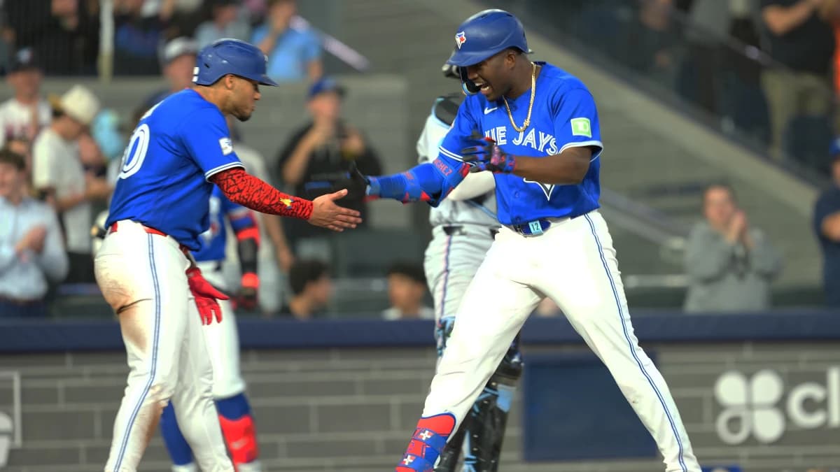 Toronto Blue Jays right fielder Jesus Sanchez (12) hits a grand slam home run and celebrates with first baseman Lenyn Sosa (50) gainst the Miami Marlins during the sixth inning at the Rogers Centre.