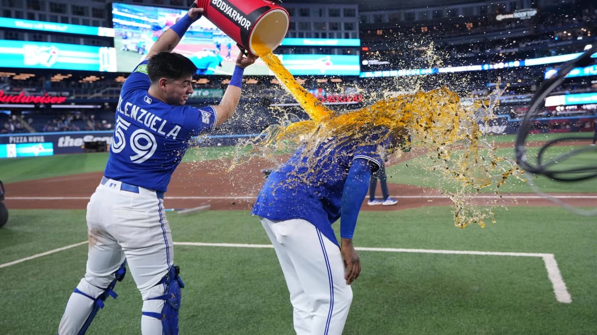 Toronto Blue Jays catcher Brandon Valenzuela (59) pours the water bucket on right fielder Jesus Sanchez (12) against the Miami Marlins at the end of the ninth inning at the Rogers Centre.
