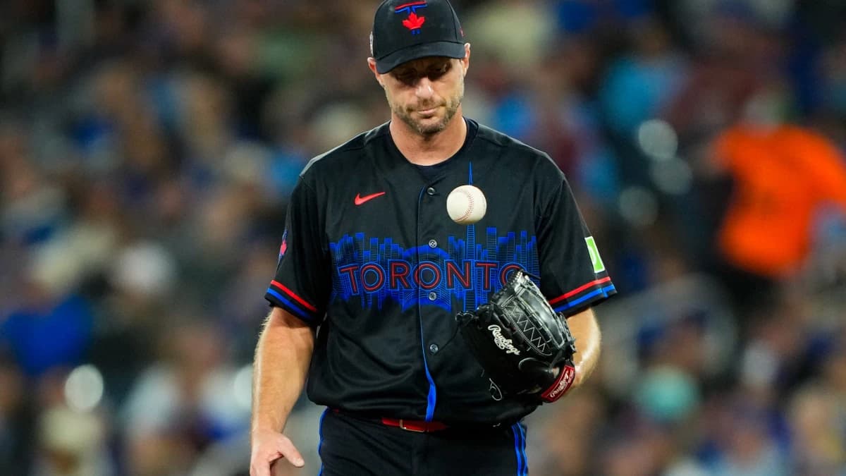 Toronto Blue Jays pitcher Max Scherzer (31) juggles the ball at a MLB game against the Cleveland Guardians at Rogers Centre.