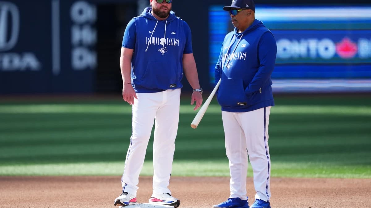 Toronto Blue Jays manager John Schneider (14) talks with associate manager DeMarlo Hale (15) during batting practice before a game against the Miami Marlins at the Rogers Centre.