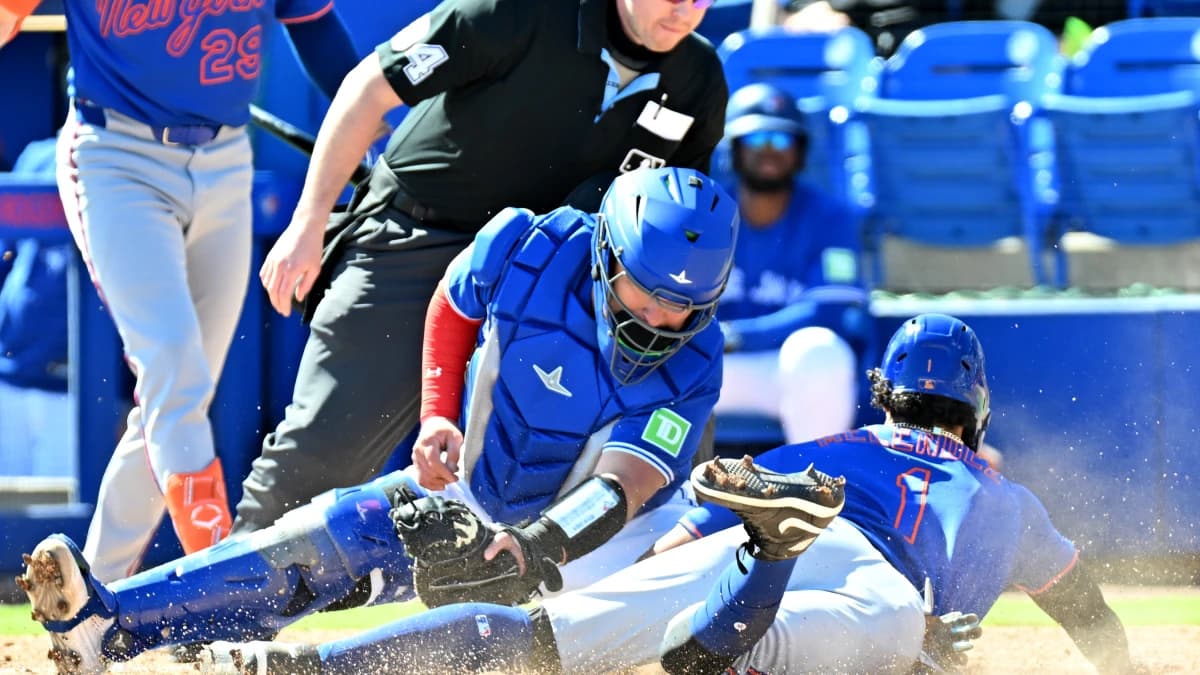 Toronto Blue Jays catcher Alejandro Kirk (30) tags out New York Mets right fielder MJ Melendez (1) on a steal attempt in the third inning during spring training at TD Ballpark.