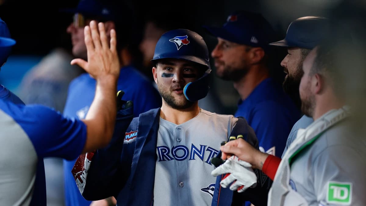 Toronto Blue Jays designated hitter Bo Bichette (11) celebrates in the dugout on a two run home run in the third inning against the Colorado Rockies at Coors Field.
